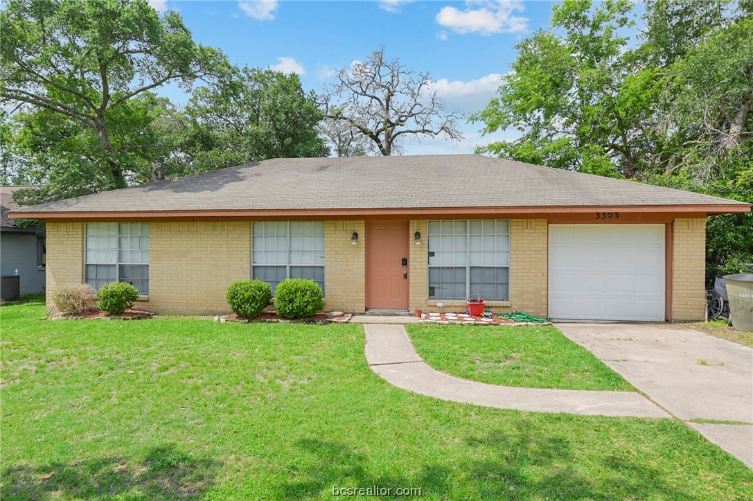a view of a house with a yard and tree