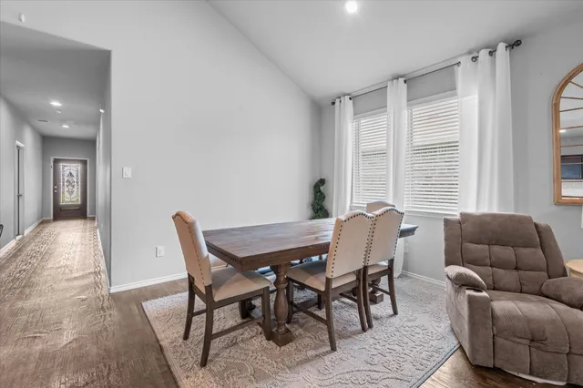 a dining room with furniture and window