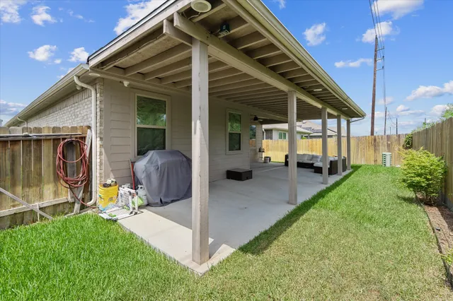 a view of a house with backyard and porch