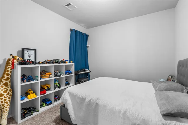 a bedroom with a bed and a book shelf