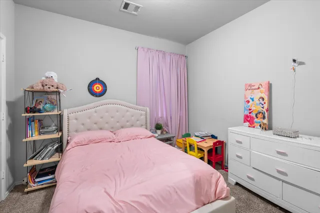 a bedroom with a bed and cabinets