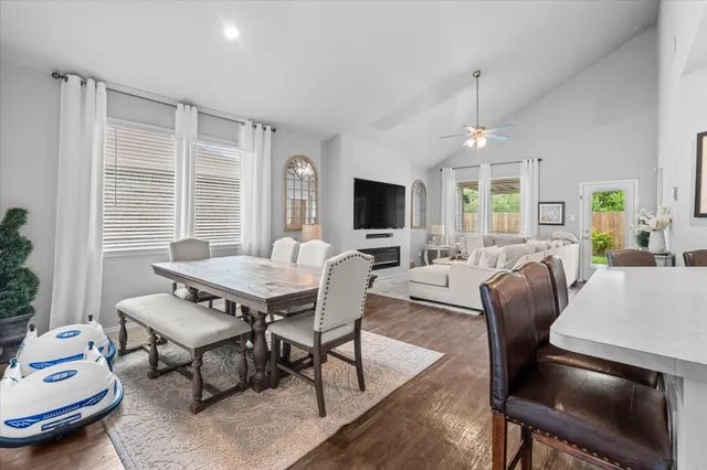 a living room with furniture a chandelier and a flat screen tv