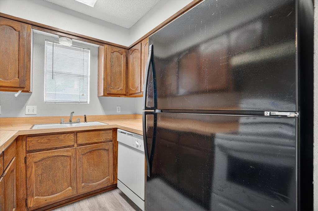 119 Del Rio Avenue, Unit C Benbrook, TX 76126 - Photo 8 of 17 a kitchen with a sink and cabinets