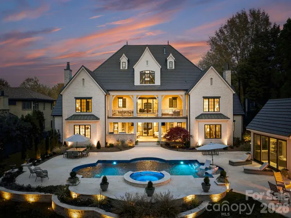 a swimming pool view with a seating space and a garden view