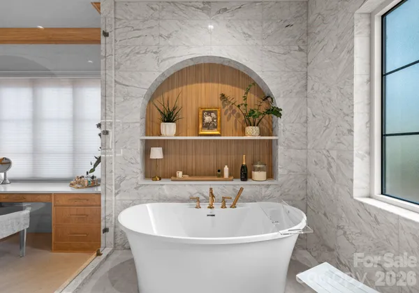 a bathroom with a sink a mirror and a tub