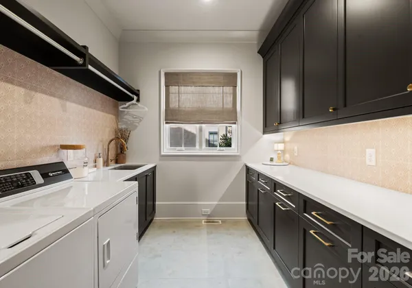 a utility room with sink dryer and washer