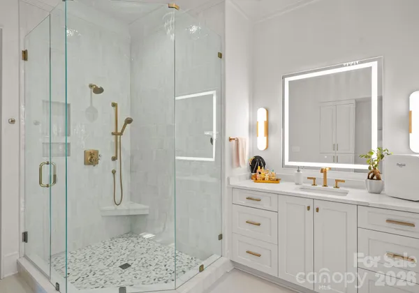 a bathroom with a granite countertop sink mirror and shower