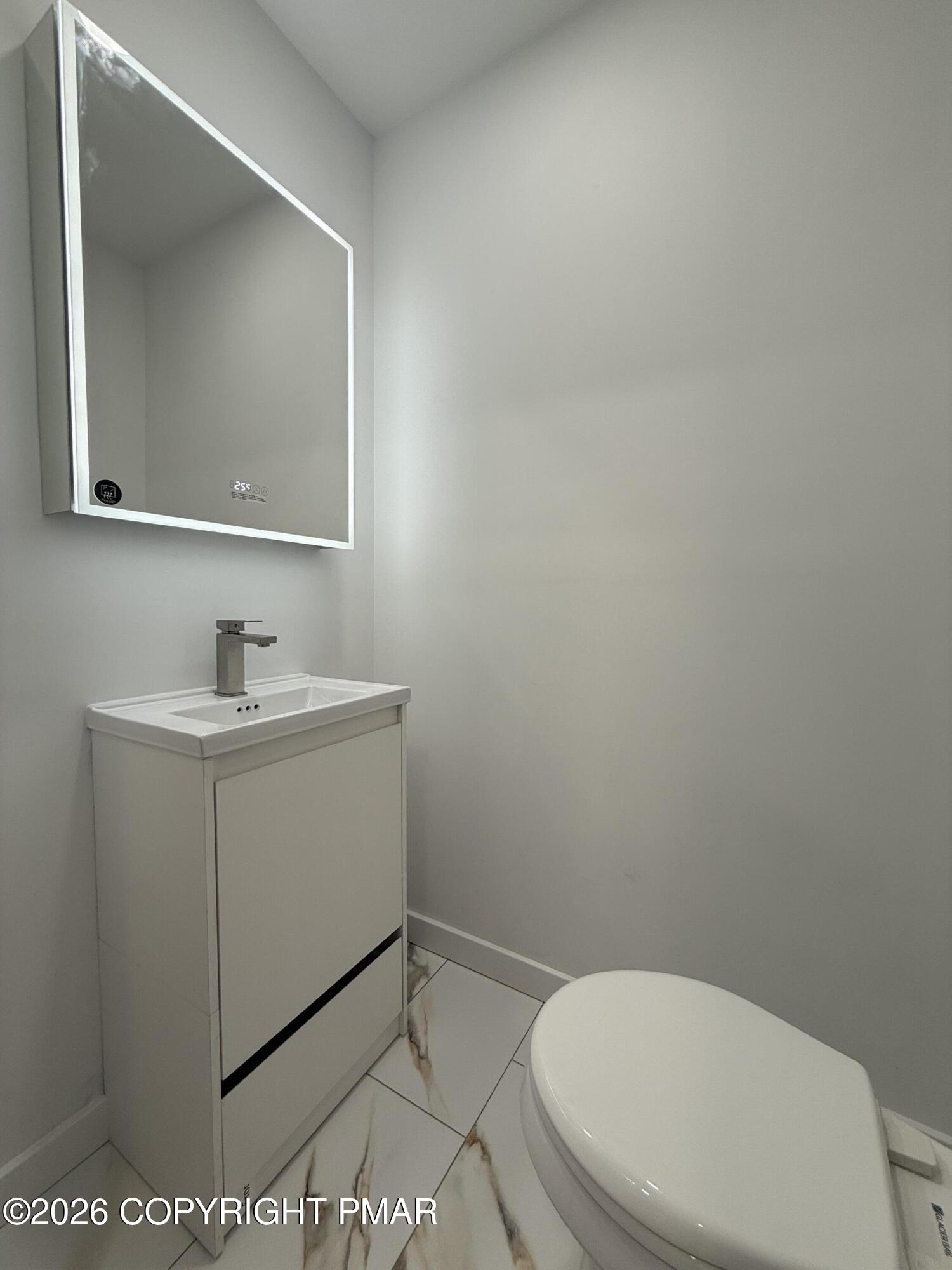 104 Condor Drive, Unit 1 Tamiment, PA 18371 - Photo 14 of 23 a bathroom with a toilet sink and mirror