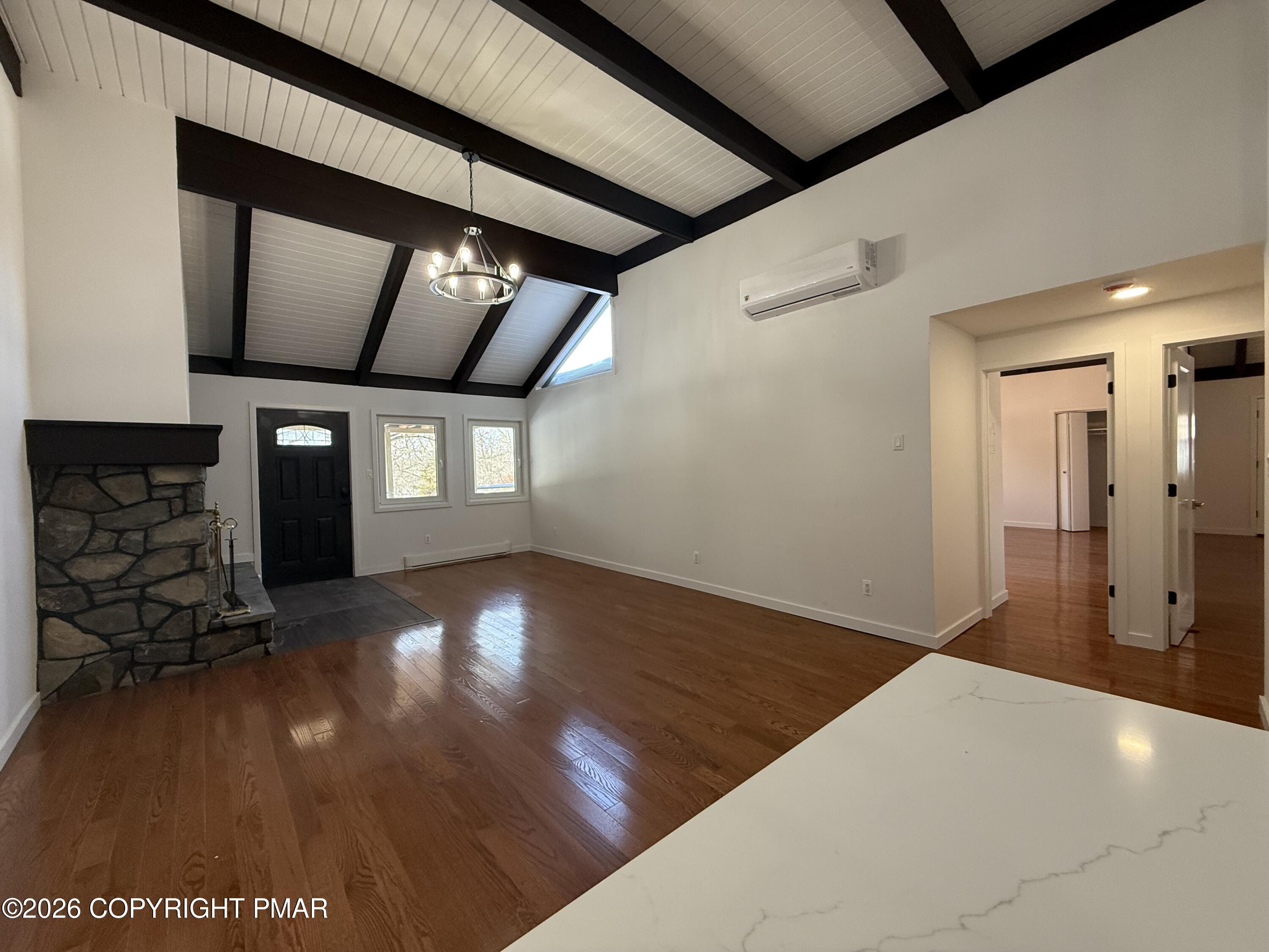 104 Condor Drive, Unit 1 Tamiment, PA 18371 - Photo 15 of 23 a view of an empty room with wooden floor and a window