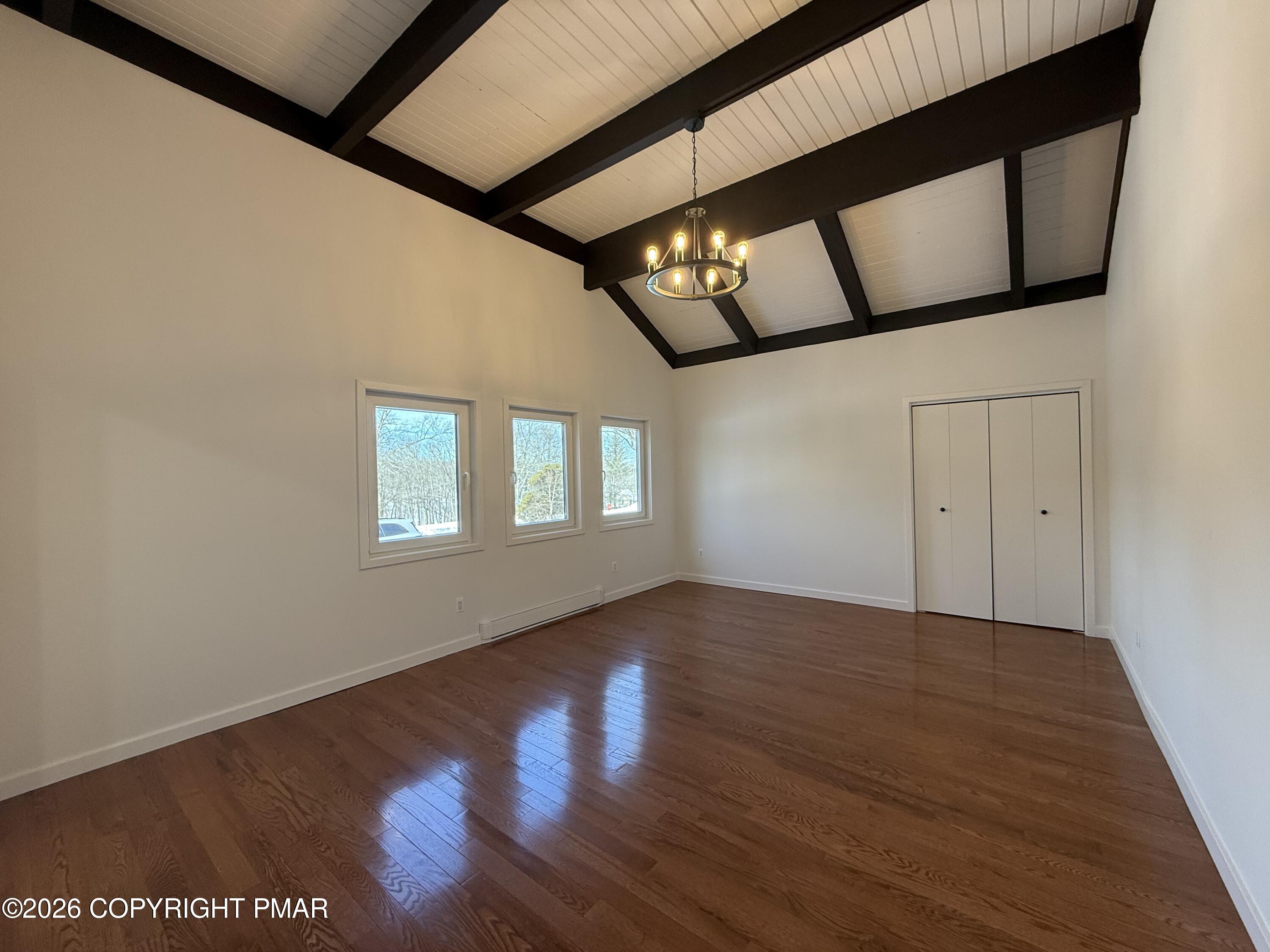 104 Condor Drive, Unit 1 Tamiment, PA 18371 - Photo 16 of 23 a view of an empty room with wooden floor and windows