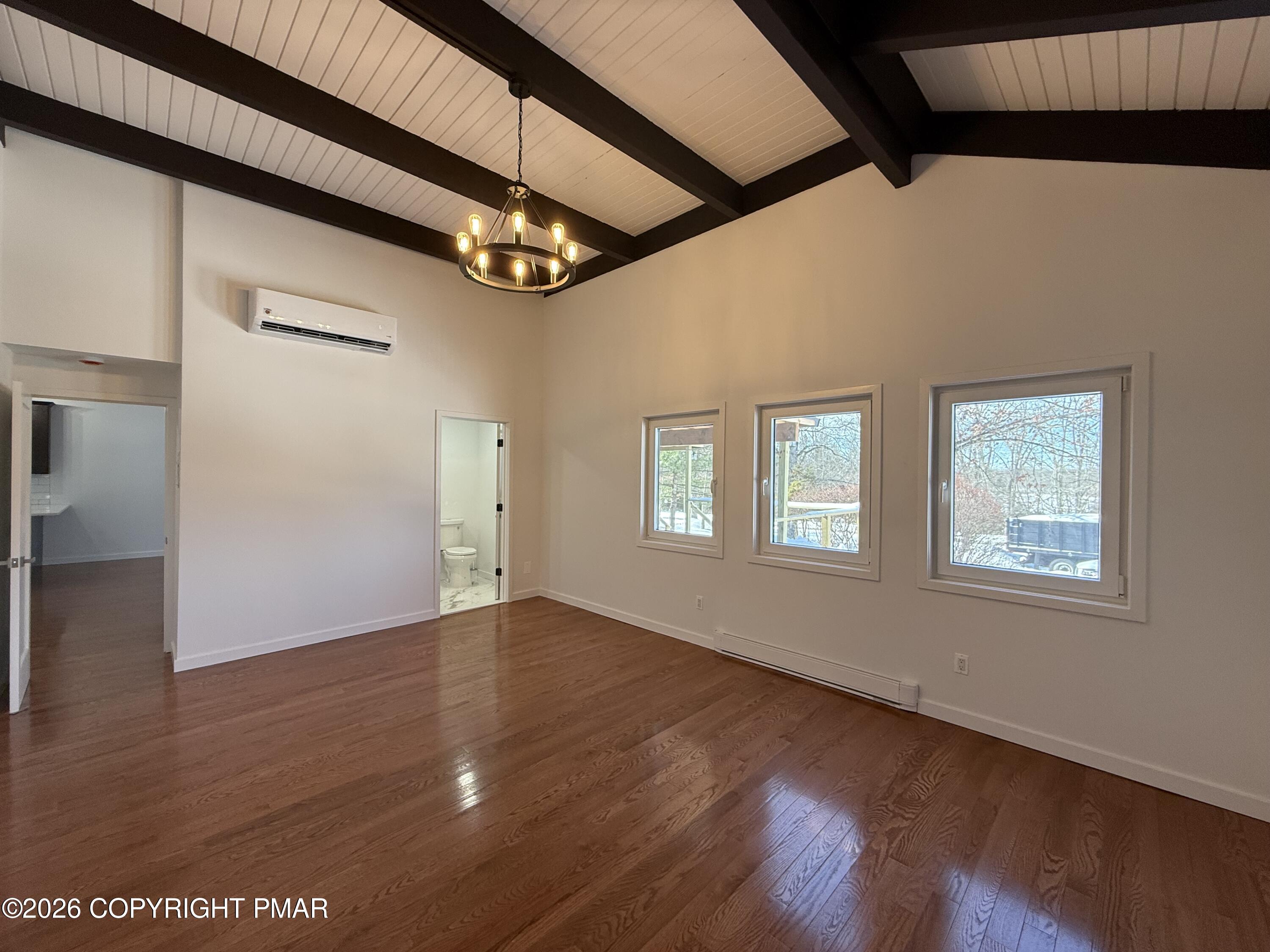 104 Condor Drive, Unit 1 Tamiment, PA 18371 - Photo 17 of 23 a view of an empty room with wooden floor and windows