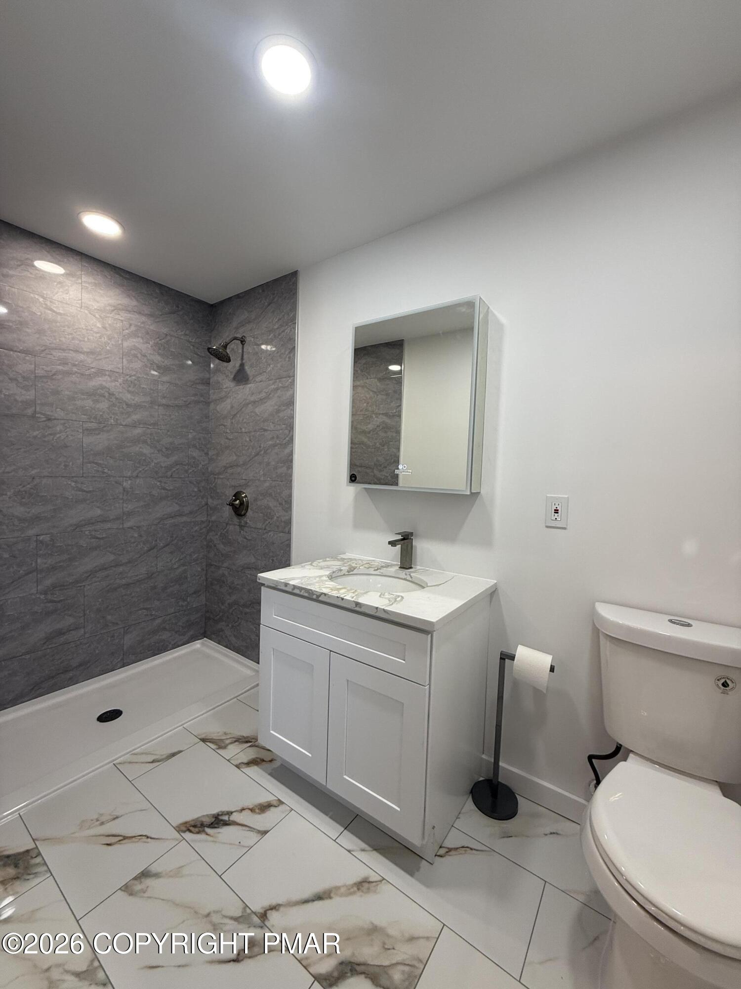 104 Condor Drive, Unit 1 Tamiment, PA 18371 - Photo 18 of 23 a bathroom with a sink a toilet and shower