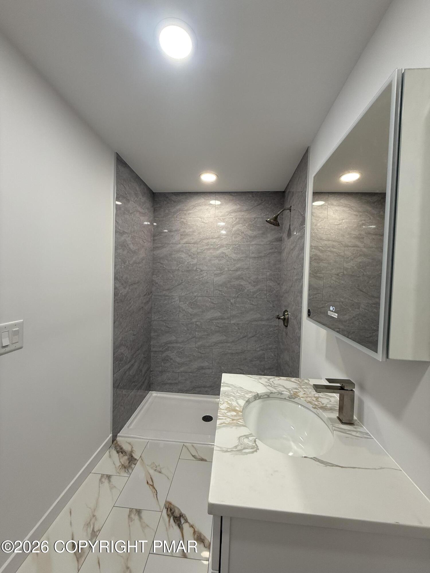 104 Condor Drive, Unit 1 Tamiment, PA 18371 - Photo 19 of 23 a bathroom with a sink and a mirror