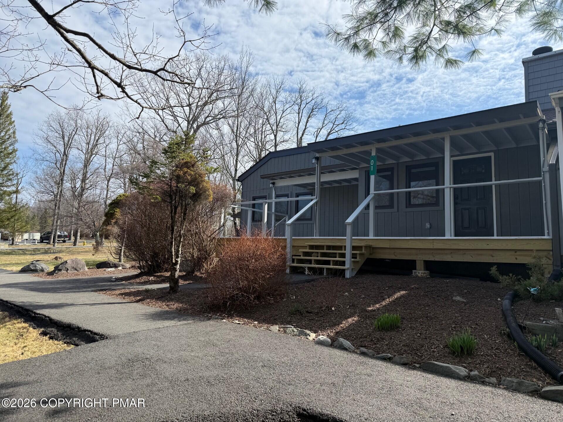 104 Condor Drive, Unit 1 Tamiment, PA 18371 - Photo 2 of 23 a front view of a house with a yard