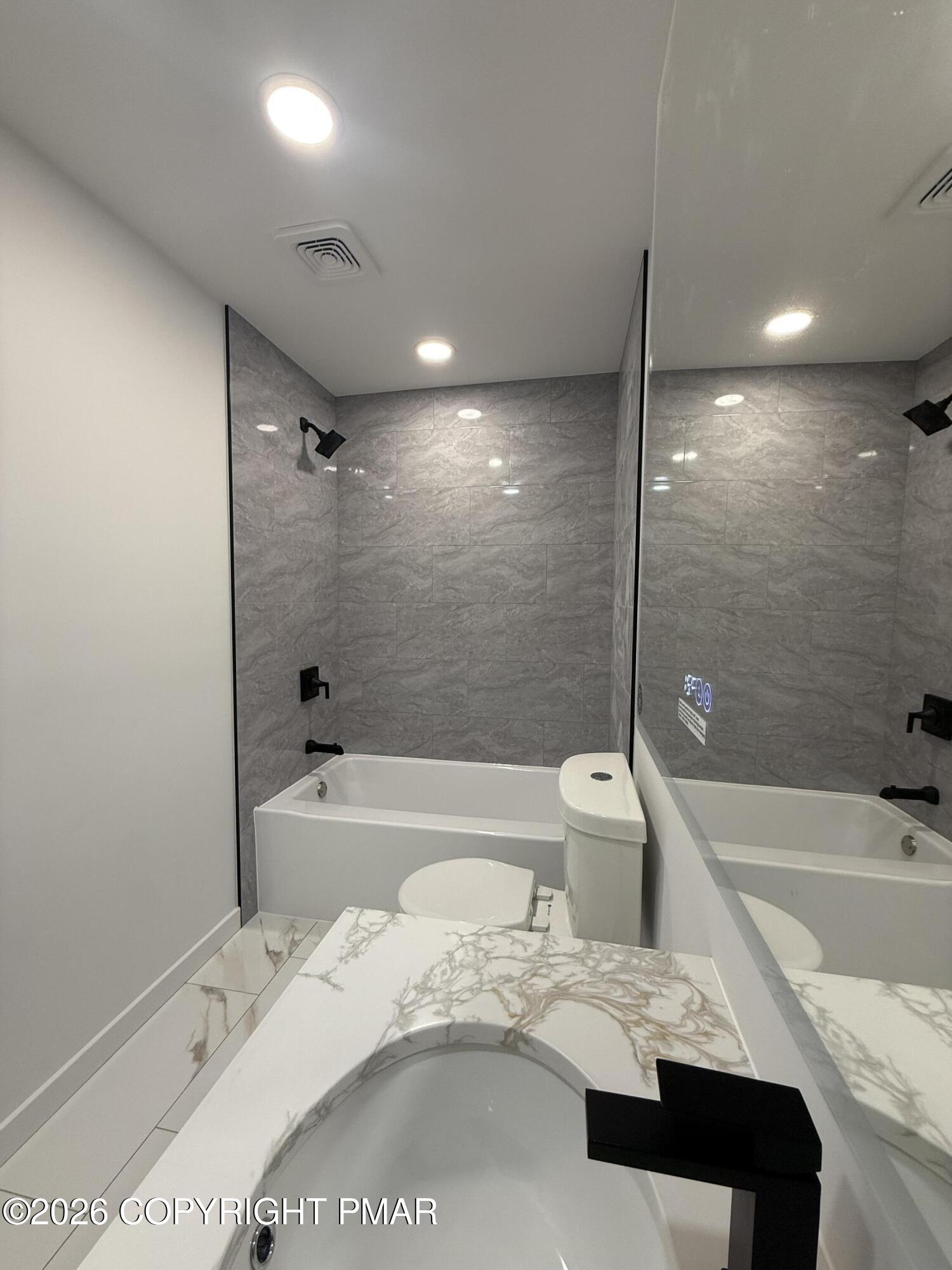 104 Condor Drive, Unit 1 Tamiment, PA 18371 - Photo 23 of 23 a bathroom with a bathtub a sink and a shower
