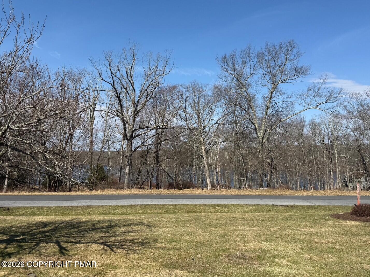 104 Condor Drive, Unit 1 Tamiment, PA 18371 - Photo 5 of 23 a view of a large swimming pool with an outdoor space and seating area