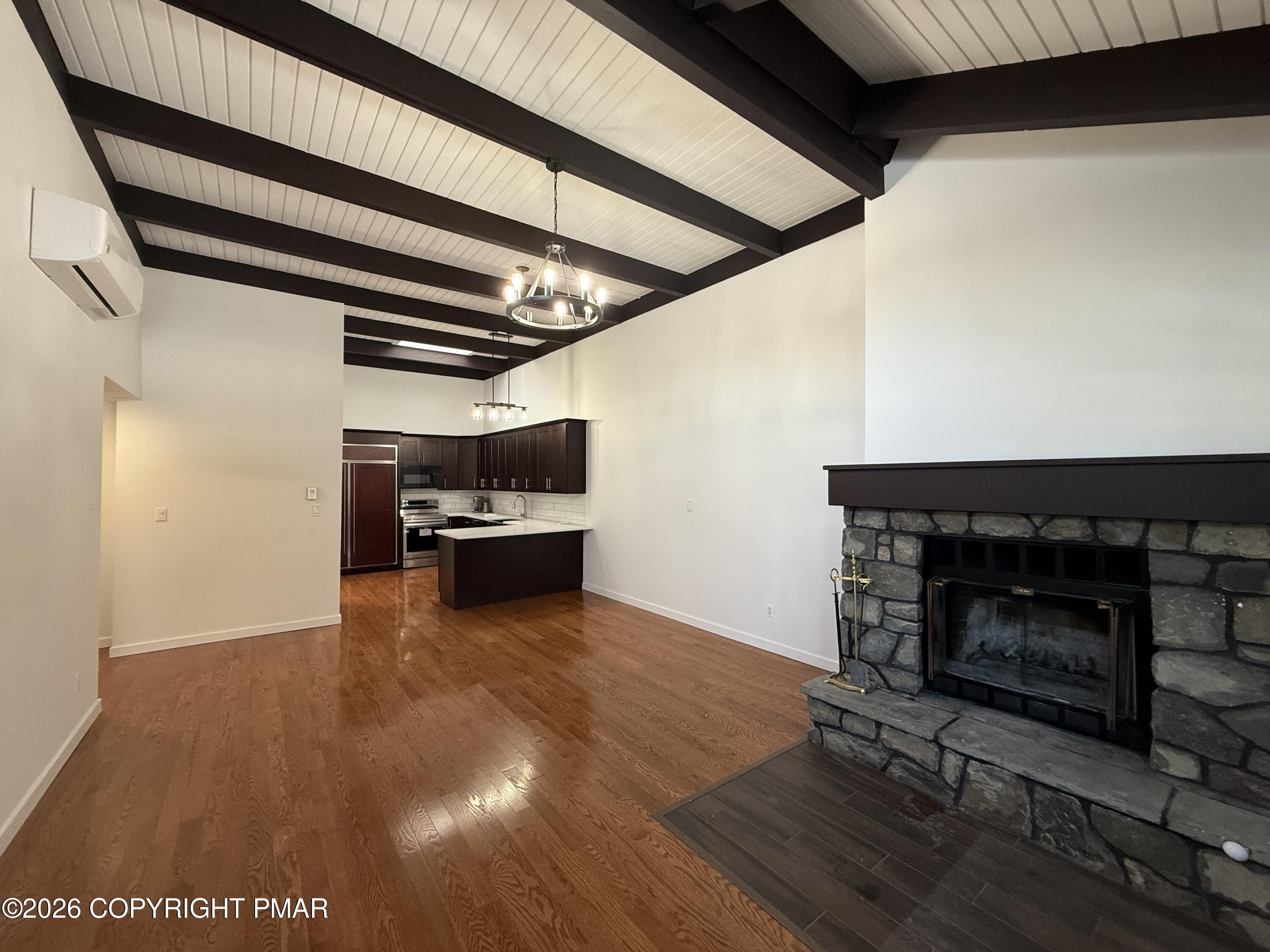 104 Condor Drive, Unit 1 Tamiment, PA 18371 - Photo 6 of 23 a view of a livingroom with furniture and a fireplace