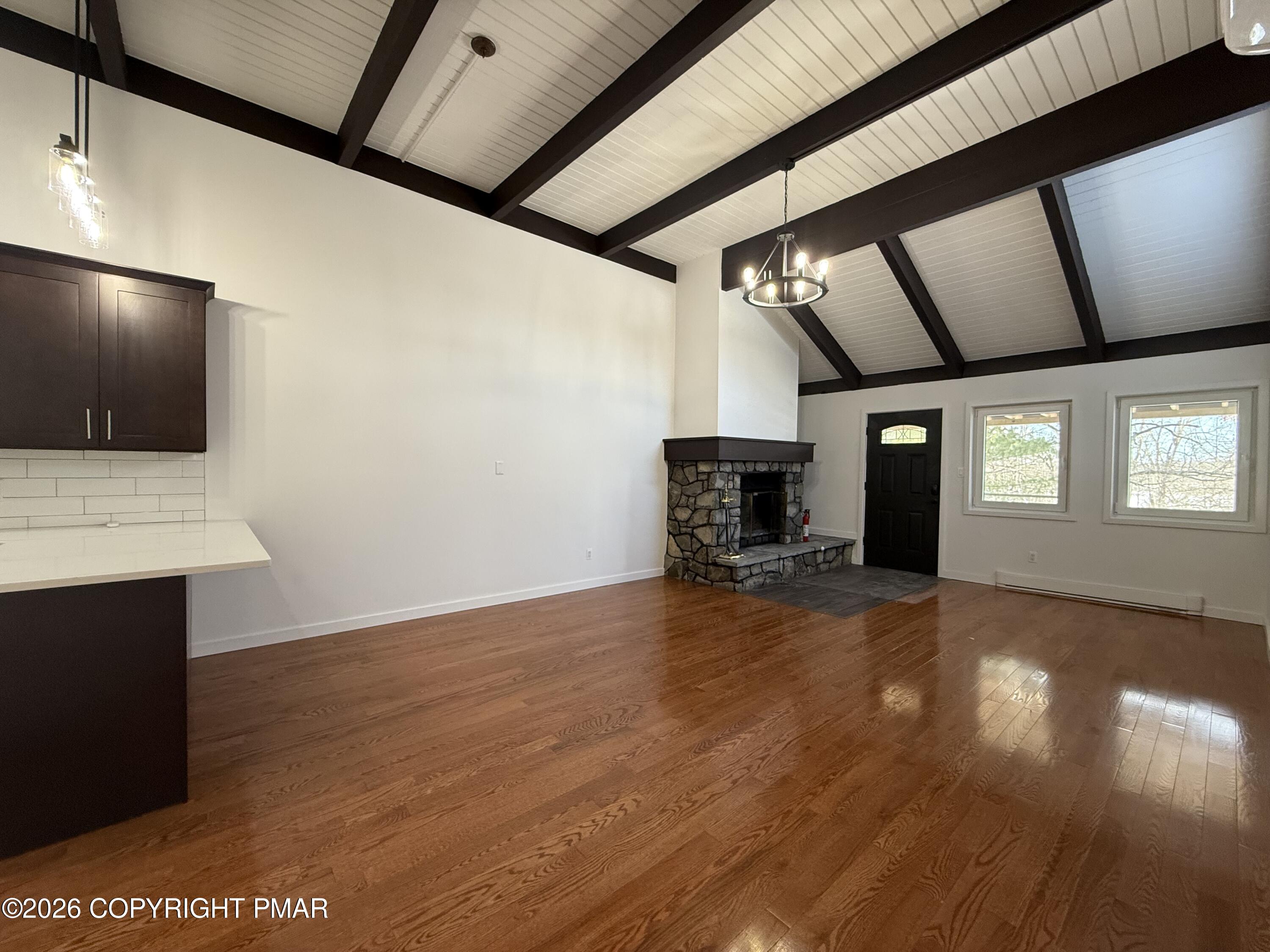 104 Condor Drive, Unit 1 Tamiment, PA 18371 - Photo 7 of 23 a view of empty room with wooden floor and fireplace