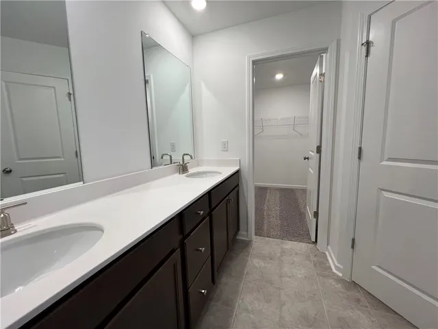 a bathroom with a double vanity sink a and mirror
