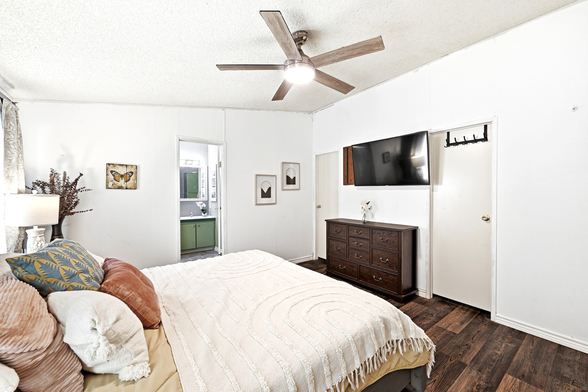 124 Coyote Lane Elgin, TX 78621 - Photo 16 of 40 a bedroom with a bed and a flat screen tv
