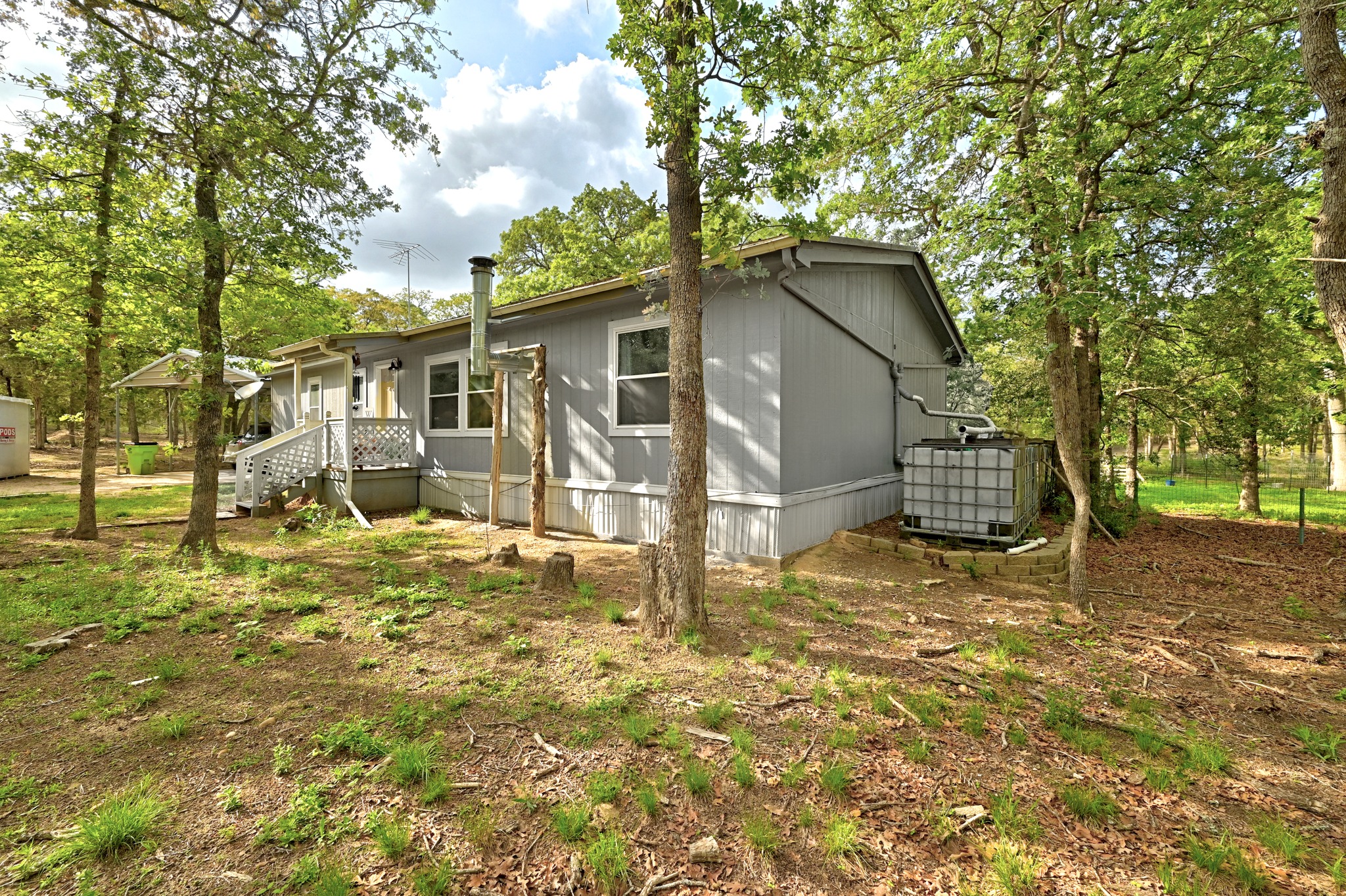 124 Coyote Lane Elgin, TX 78621 - Photo 2 of 40 a backyard of a house with table and chairs