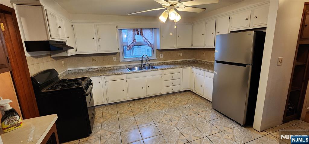 39 Hopper Street, Unit 1 Prospect Park, NJ 07508 - Photo 2 of 7 a kitchen with stainless steel appliances a refrigerator sink and cabinets