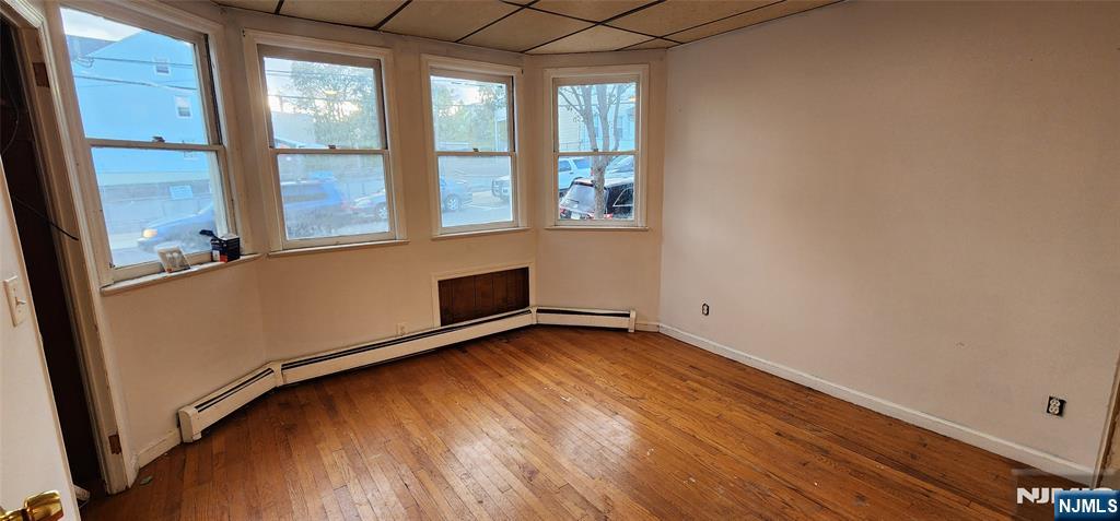 39 Hopper Street, Unit 1 Prospect Park, NJ 07508 - Photo 4 of 7 a view of an empty room with a window and wooden floor