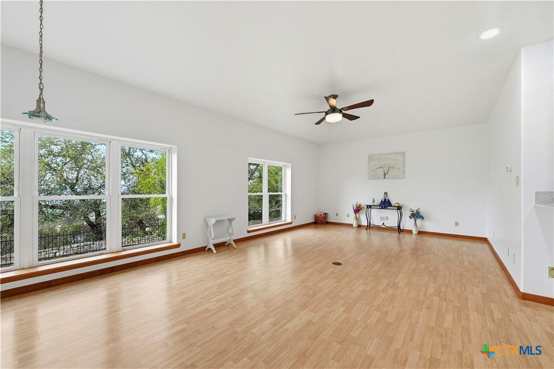 3328 Eagle Ridge Drive Harker Heights, TX 76548 - Photo 15 of 48 a view of a livingroom with a large window wooden floor and a ceiling fan