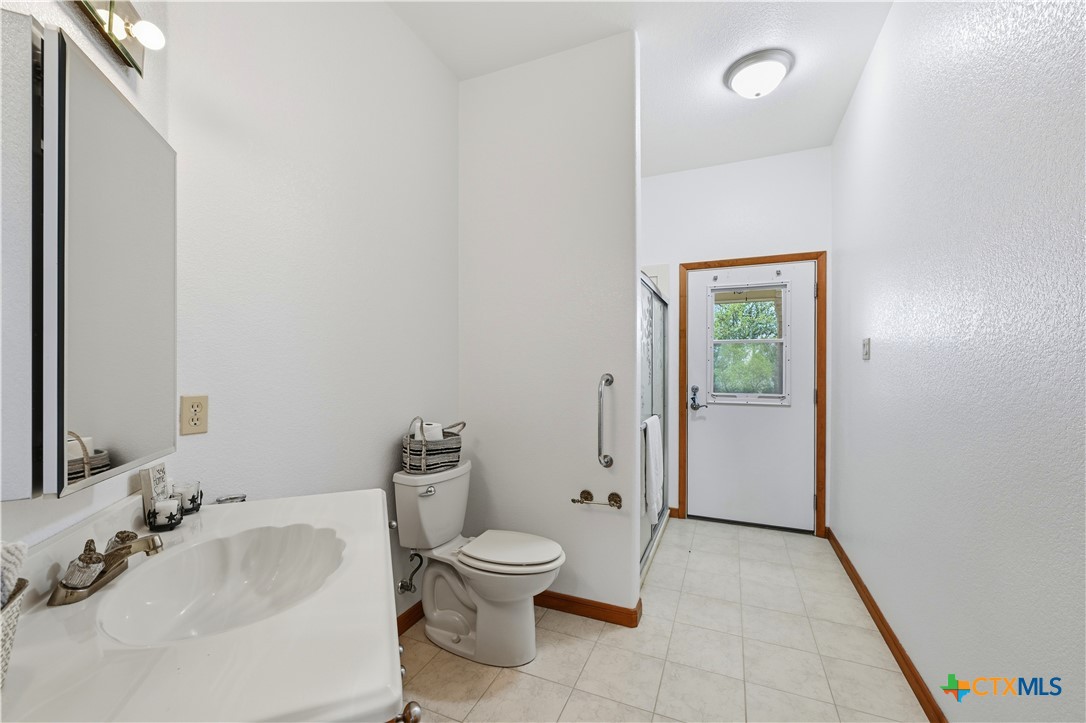 3328 Eagle Ridge Drive Harker Heights, TX 76548 - Photo 28 of 48 a bathroom with a toilet sink and shower