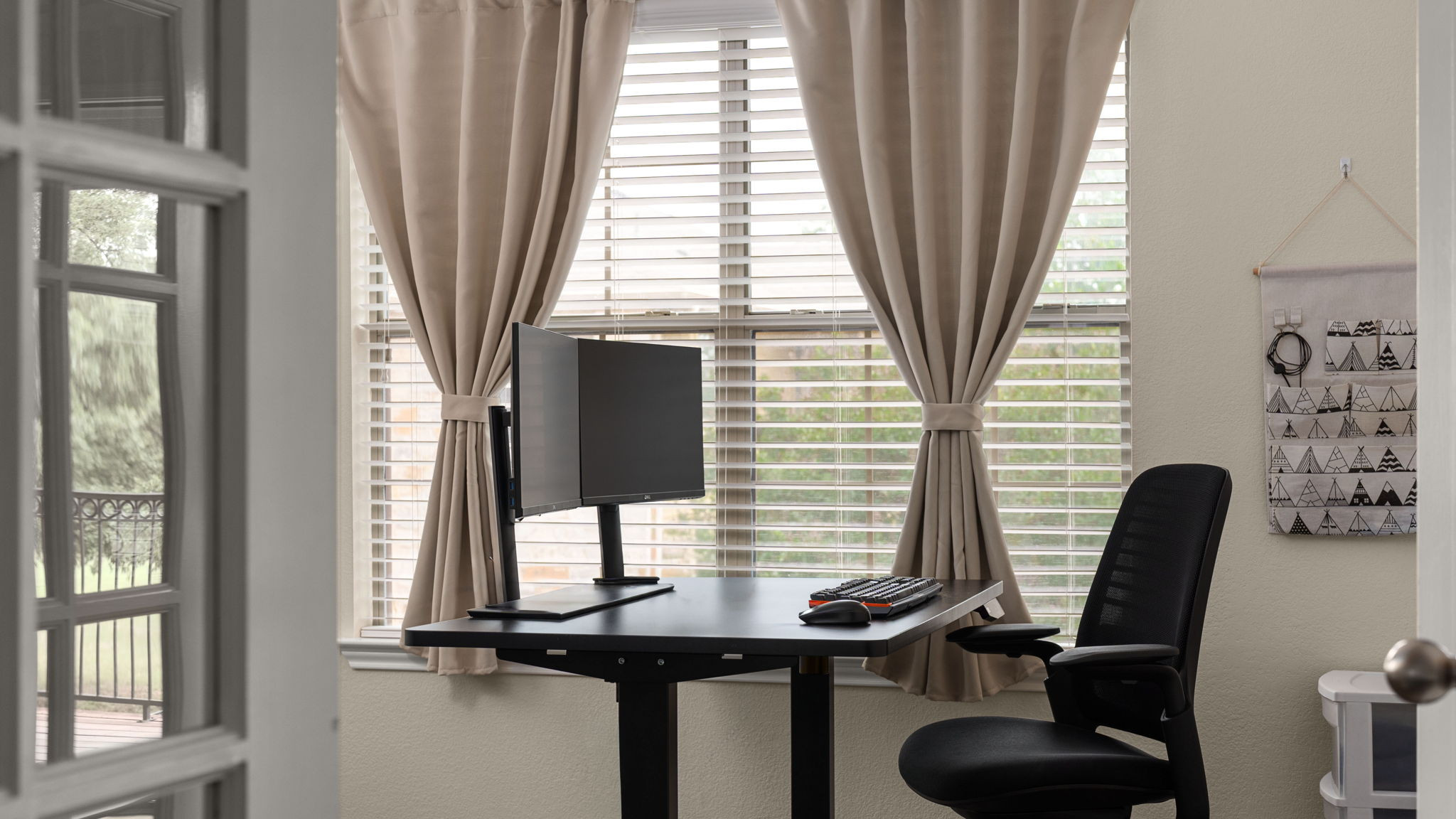 14815 Avery Ranch Boulevard, Unit 1401 Austin, TX 78717 - Photo 19 of 38 Double French doors open into a versatile room featuring a large window with blinds and beige drapes, offering natural light
