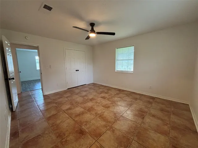 a bathroom with a granite countertop sink a toilet and bathtub