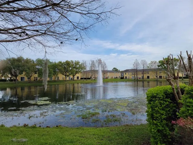 a view of a lake with houses in back