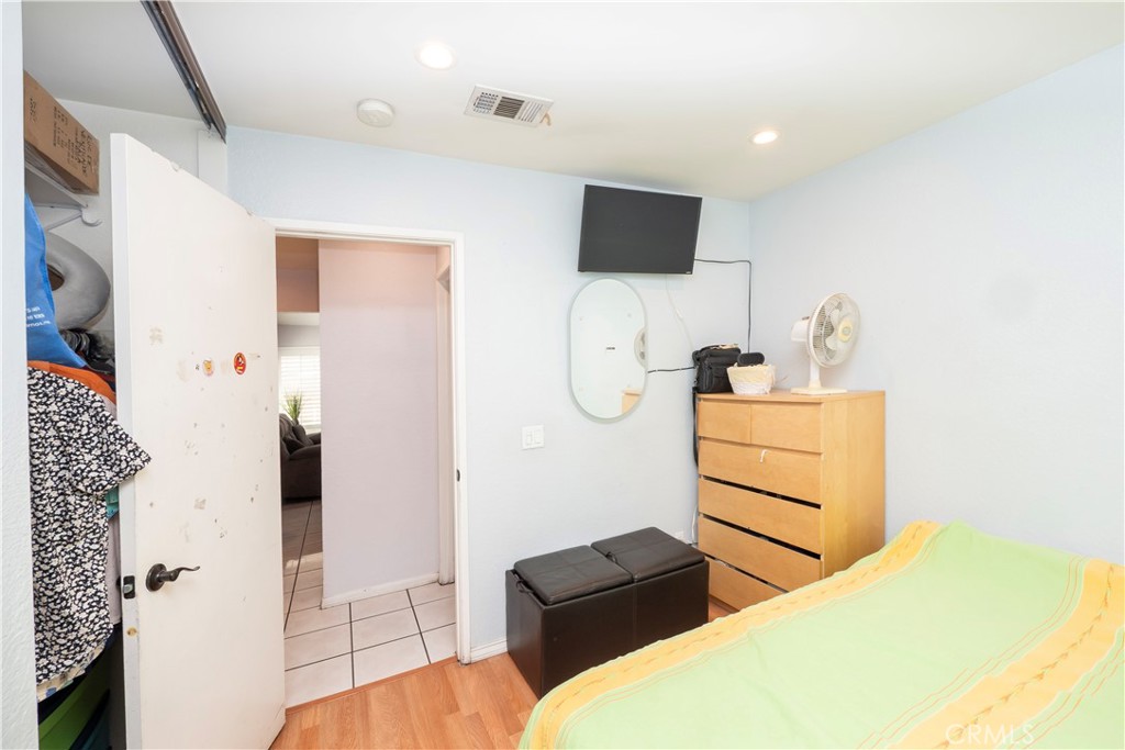 14018 Ridgewood Drive Fontana, CA 92337 - Photo 14 of 30 a bedroom with a bed and flat screen tv