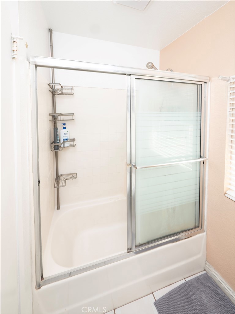14018 Ridgewood Drive Fontana, CA 92337 - Photo 15 of 30 a bathroom with a shower and a bath tub