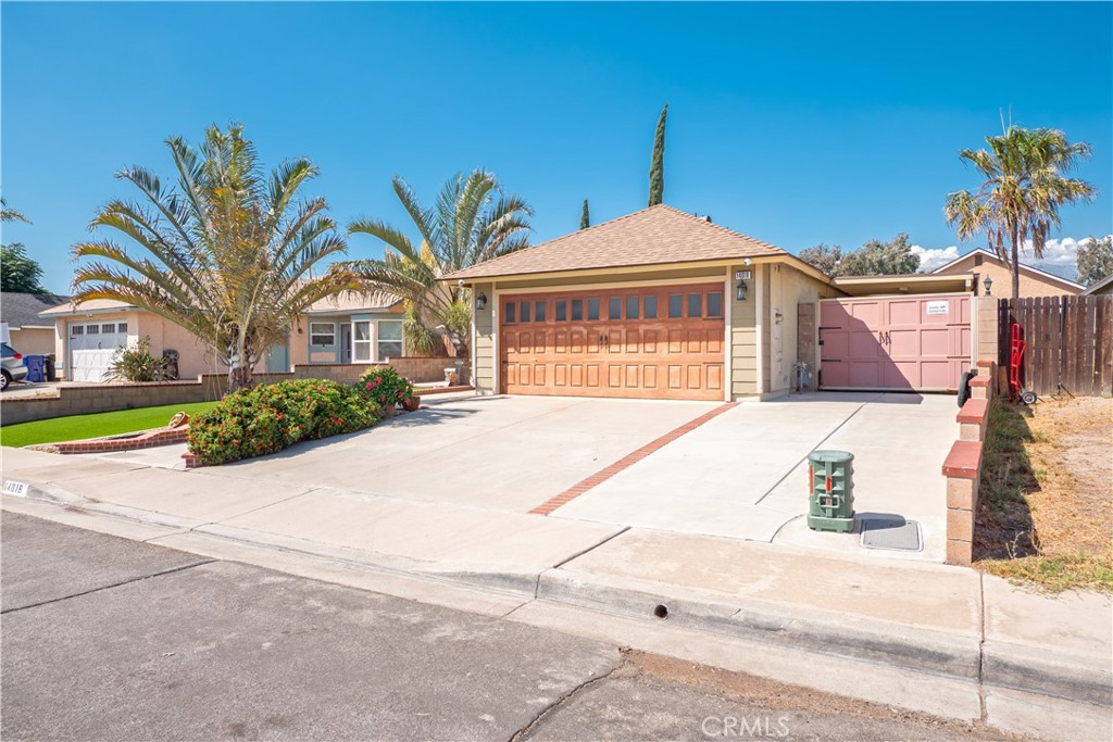 14018 Ridgewood Drive Fontana, CA 92337 - Photo 2 of 30 a front view of a house with a yard