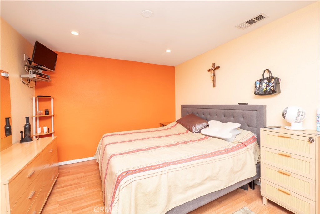 14018 Ridgewood Drive Fontana, CA 92337 - Photo 9 of 30 a bedroom with a bed and a flat screen tv