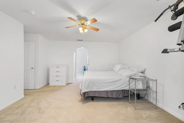 a bedroom with a bed and a chandelier