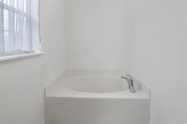 a white bath tub sitting in a bathroom