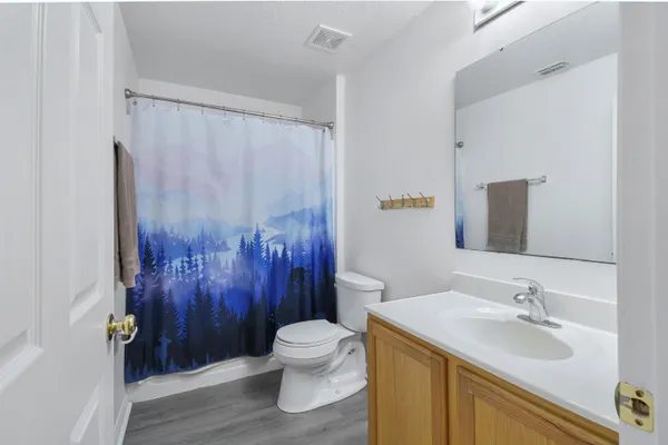 a bathroom with a sink toilet and shower