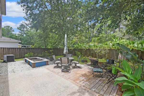 a view of a patio with chairs and plants