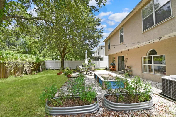 a view of an house with backyard porch and furniture