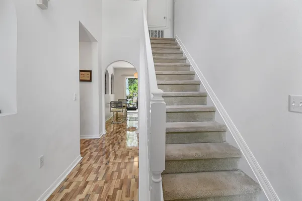 a view of entryway and hall with wooden floor