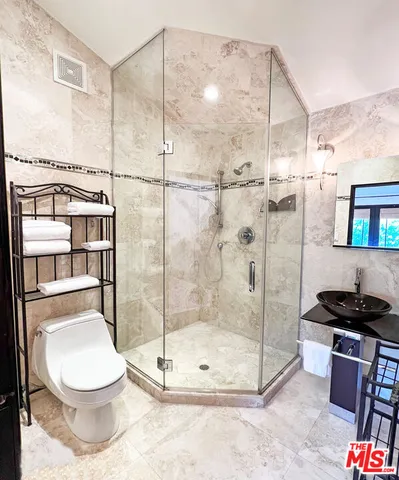 a bathroom with a toilet and a shower