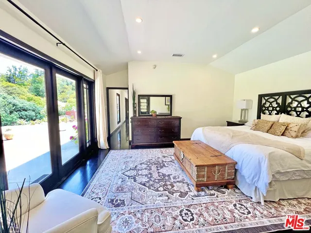 a bedroom with a large bed and a couch