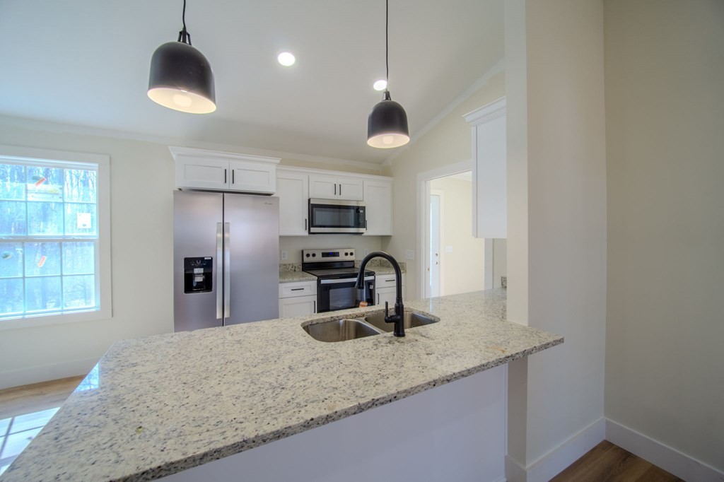 478 Hickory Lane Sparta, TN 38583 - Photo 11 of 43 a kitchen with stainless steel appliances granite countertop a sink refrigerator and microwave