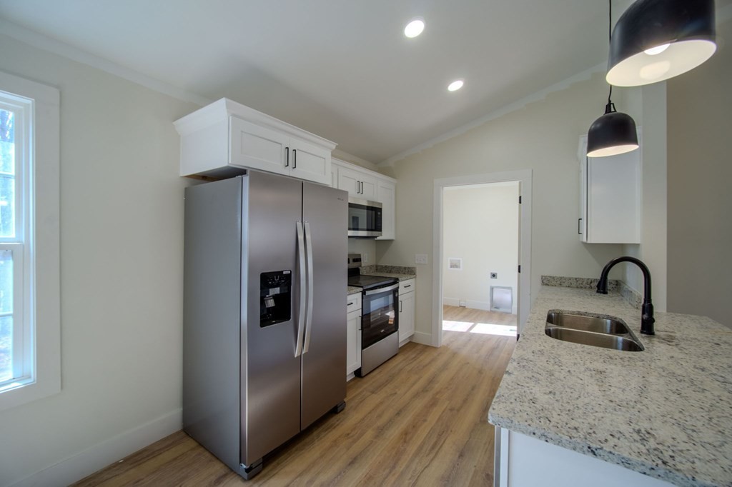 478 Hickory Lane Sparta, TN 38583 - Photo 13 of 43 a kitchen with granite countertop a refrigerator and a sink