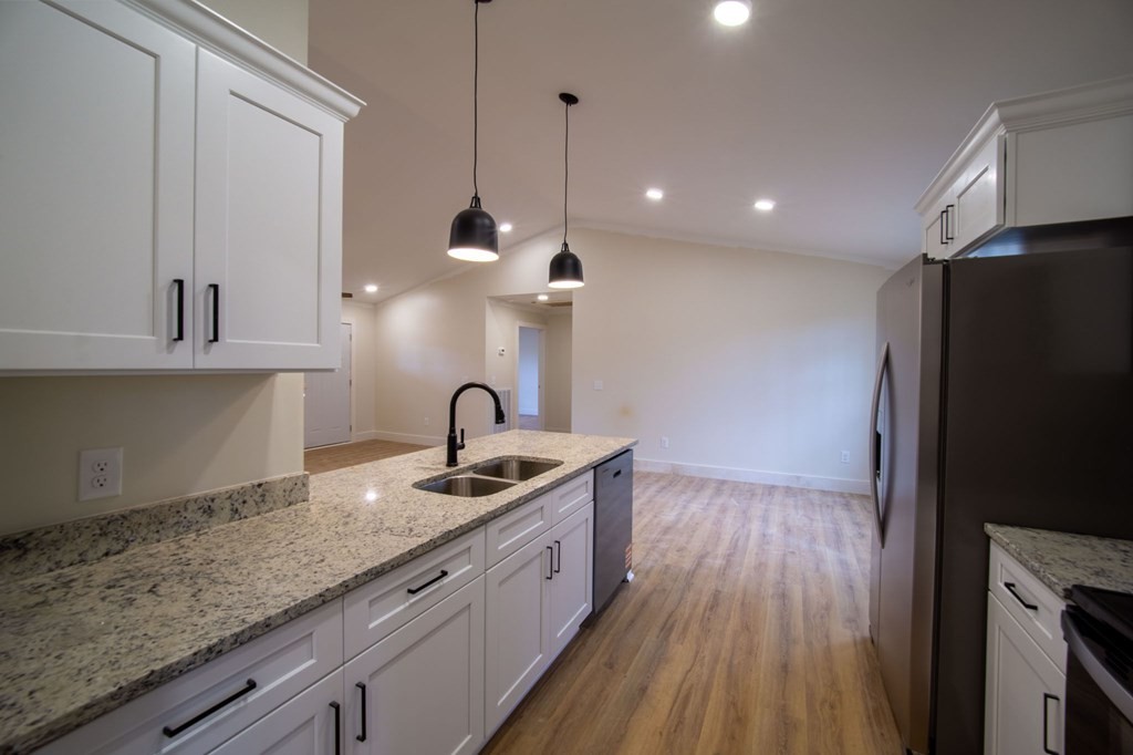 478 Hickory Lane Sparta, TN 38583 - Photo 15 of 43 a kitchen with stainless steel appliances granite countertop a sink a stove and a wooden floors