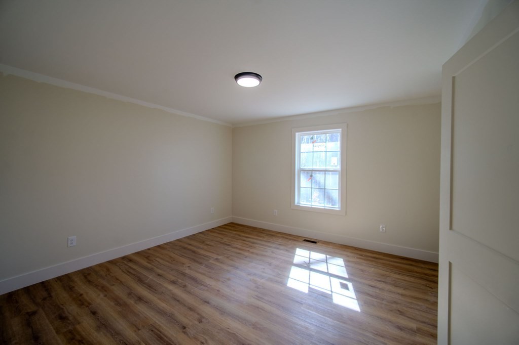 478 Hickory Lane Sparta, TN 38583 - Photo 27 of 43 an empty room with wooden floor and windows