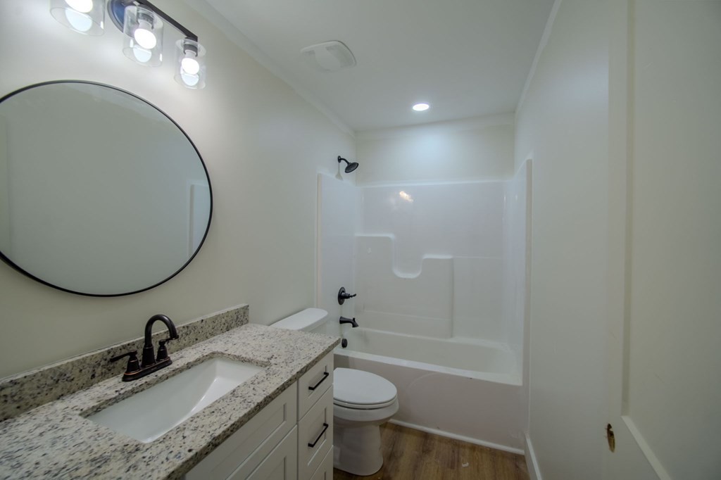 478 Hickory Lane Sparta, TN 38583 - Photo 31 of 43 a bathroom with a granite countertop sink toilet and a mirror