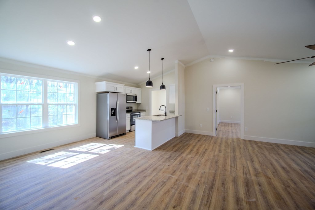 478 Hickory Lane Sparta, TN 38583 - Photo 8 of 43 an empty room with wooden floor and windows